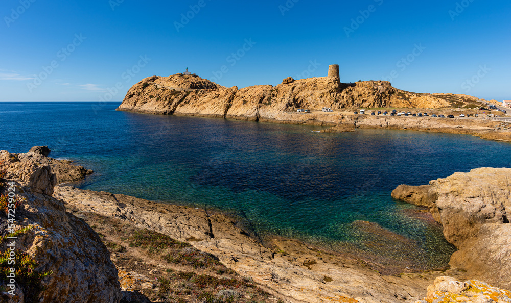 The old lighthouse and the Genoese tower on the rocky Pietra peninsula in the L'Ile-Rousse commune of France on Corsica, France