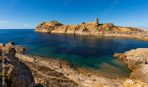 The old lighthouse and the Genoese tower on the rocky Pietra peninsula in the L'Ile-Rousse commune of France on Corsica, France