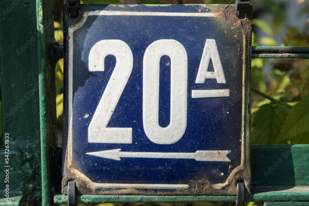 Weathered grunge square metal enameled plate of number of street address with number 20