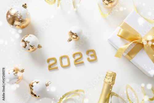 Canvas Print Festive New Year party composition with number of 2023 year, gold Christmas baubles, golden and white decorations on white background