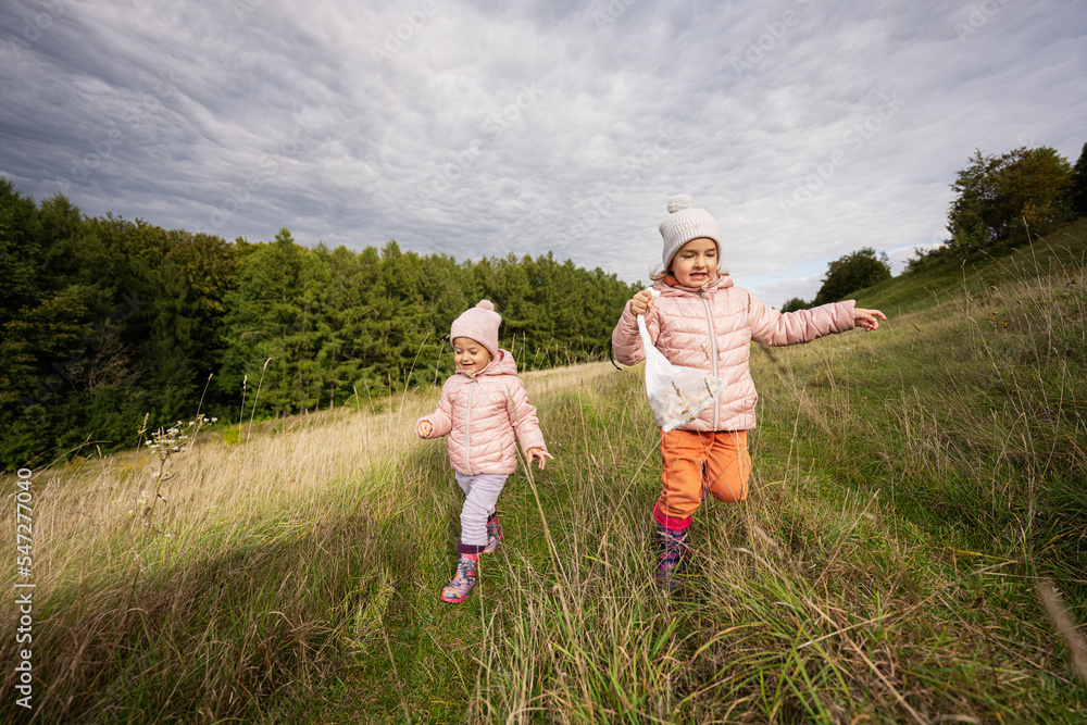Fototapeta premium Sisters having fun and run outdoor near forest.