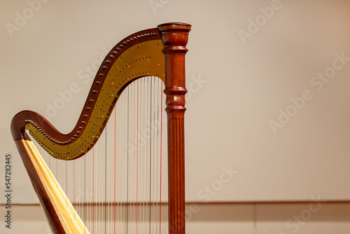 Photo Partial view of a concert harp against a light background