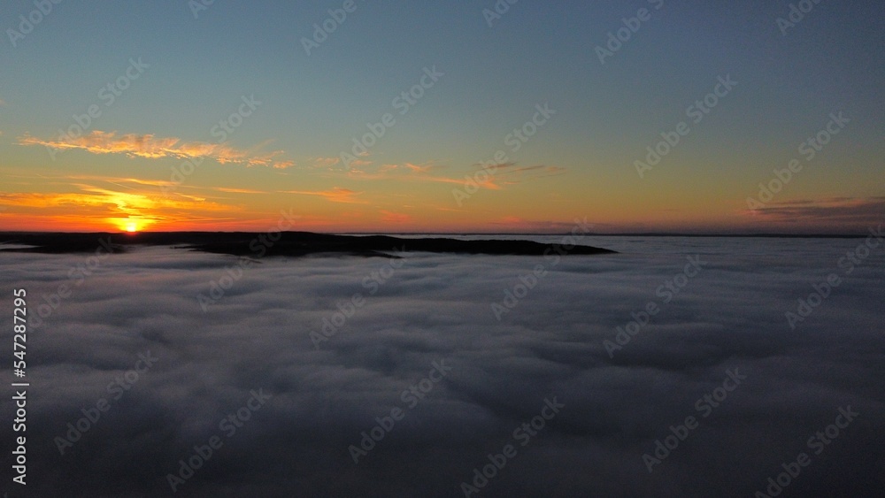 Sunset over the clouds