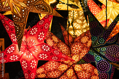 Illuminated Paper Stars on a Christmas Market