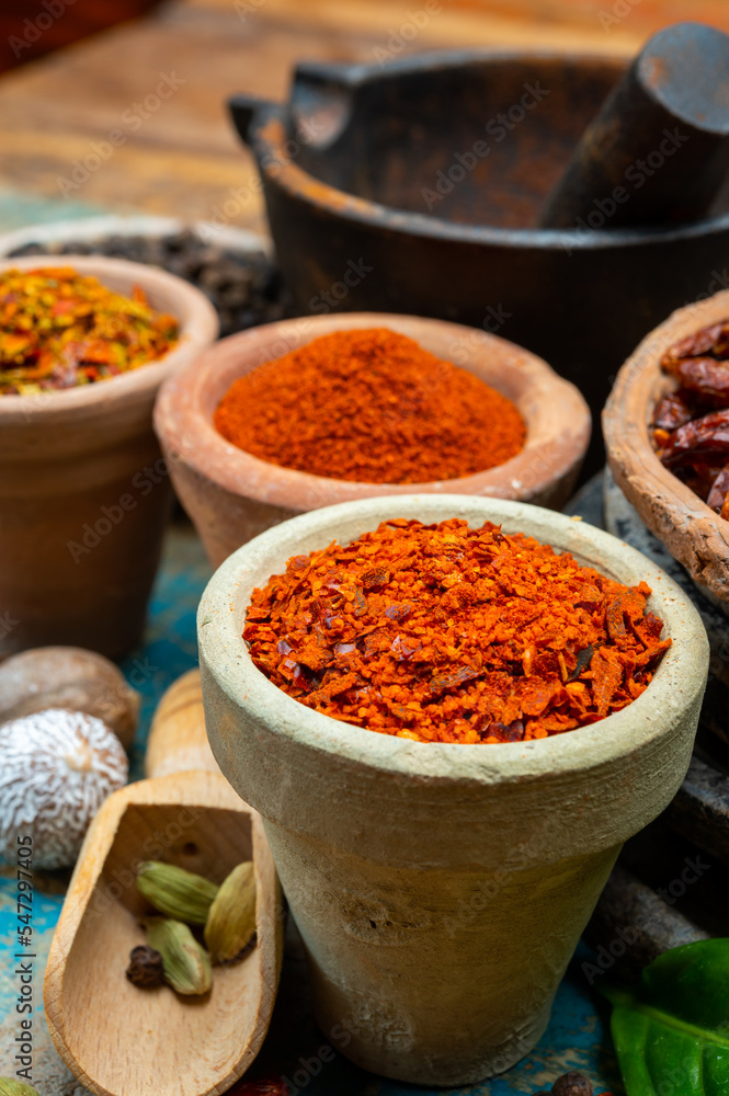 Colorful ground spicy chili peppers , pimento and curcuma is clay pots close up Colorful ground spicy chili peppers , pimento and curcuma is clay pots close up