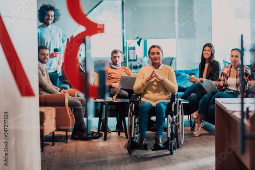 Wallpaper Mural Businesswoman in wheelchair having business meeting with team at modern office. A group of young freelancers agree on new online business projects Torontodigital.ca