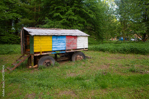 Historic colorful apiary on wheels near the forest © pictory