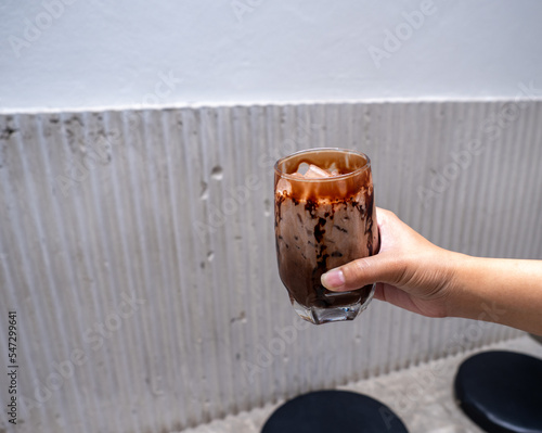 dirty coffee on hand with concrete background
