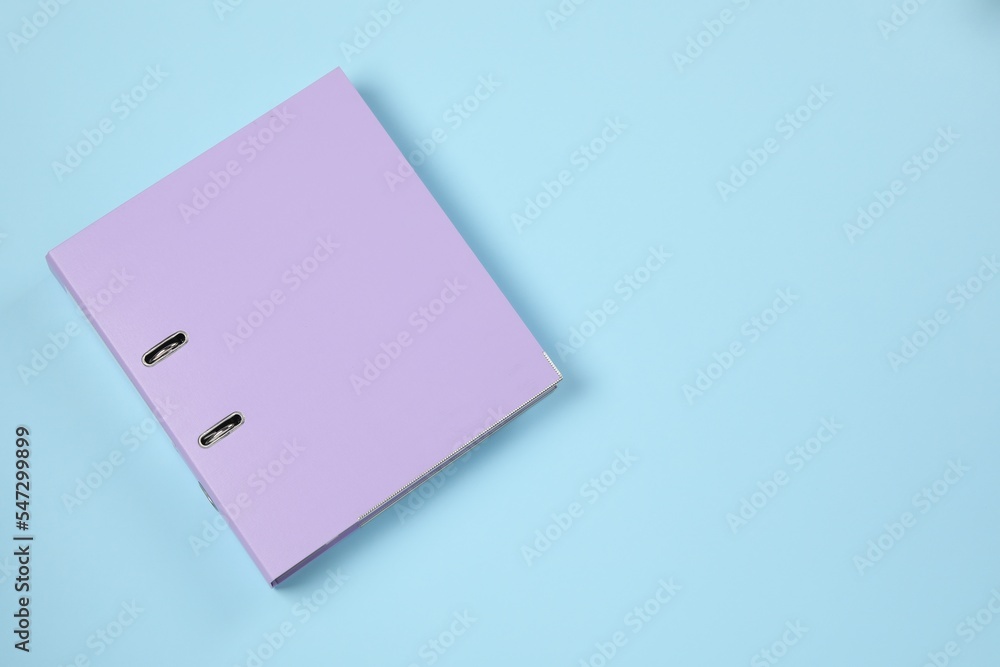 One office folder on light blue background, top view. Space for text One office folder on light blue background, top view. Space for text