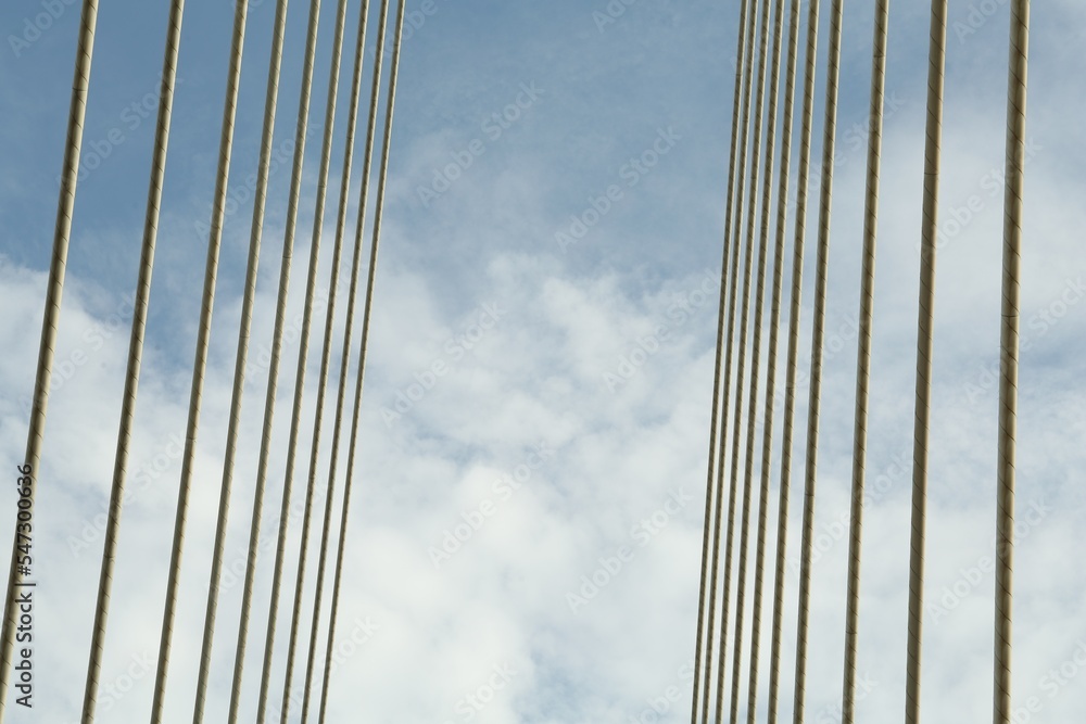 Modern bridge cables against blue sky, low angle view Modern bridge cables against blue sky, low angle view