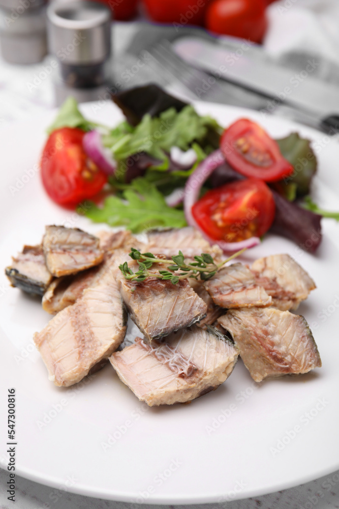 Delicious canned mackerel chunks served on white table, closeup