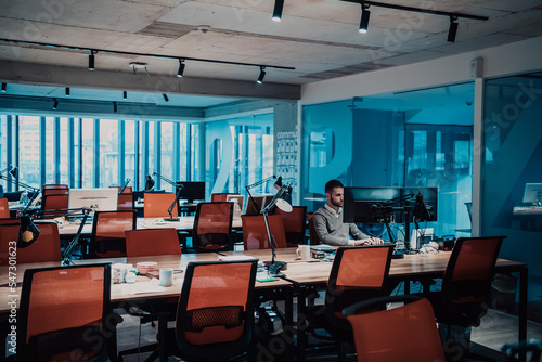 Modern Office: Portrait of Stylish Businessman Works on Computer, Does Data Analysis and Creative Designer, Looks at Camera and Smiles. Digital Entrepreneur Works on e-Commerce Startup Project