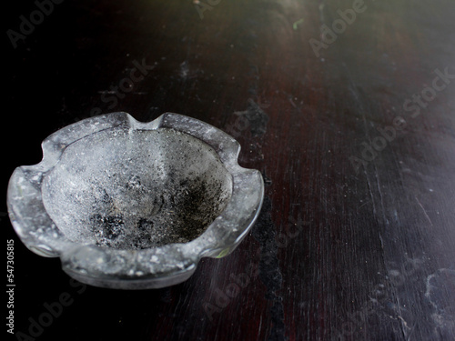 glass ashtray on black background photo