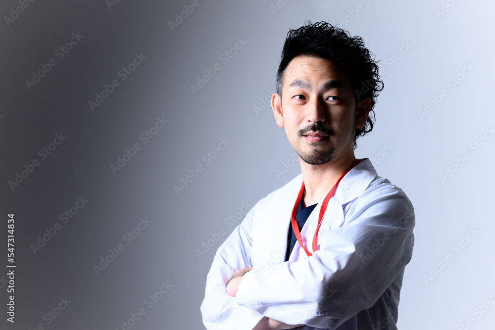 For recruitment, career change, etc. Image of a mid-level male doctor wearing a white coat.
