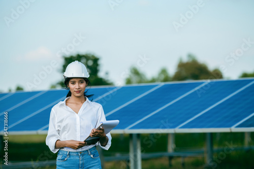 Asian young engineer female checking operation in solar farm