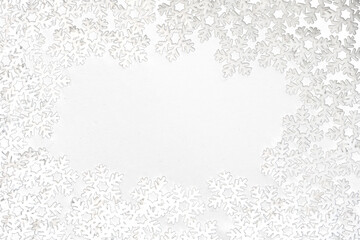 Frame of small white felt snowflakes, celebrating winter holidays
