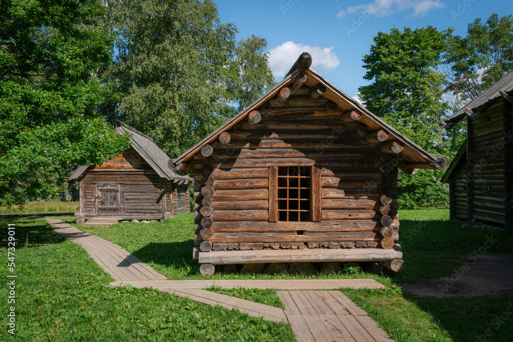 View of the log wooden house in the Novgorod Museum of Folk Wooden Architecture of Vitoslavlitsa on a sunny summer day, Veliky Novgorod, Russia