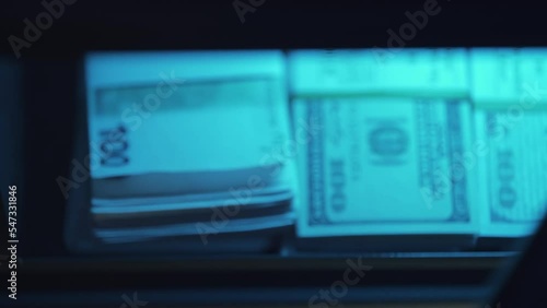 A businessman is dialing secret code and opening safe and putting money. Strongbox with pile of cash. Banking deposit box. Euros and dollars savings. Concept of finance safety or business security