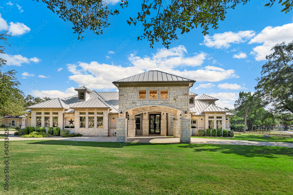 A luxury white home with a green lawn A luxury white home with a green lawn