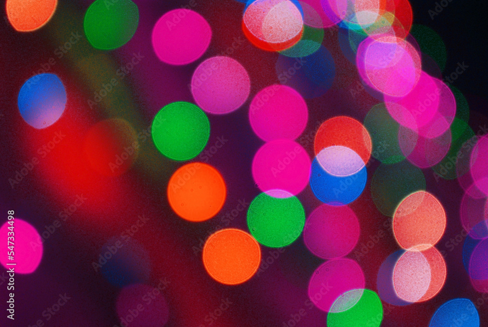 Christmas background from defocused colored circles from a lit Christmas tree garland. Christmas background from defocused colored circles from a lit Christmas tree garland.