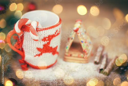 Christmas Cup ornament and sweets on wooden background.