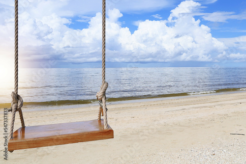 Swings hanging on the beach by the sea and sunny during the midday summer holidays © AREE