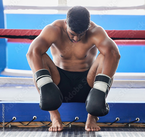 Boxer, martial arts and man tired and sad after boxing or sports competition mistake, failure or stress, anxiety and depression pre workout. Athlete man worried about exercise or fight at boxing ring