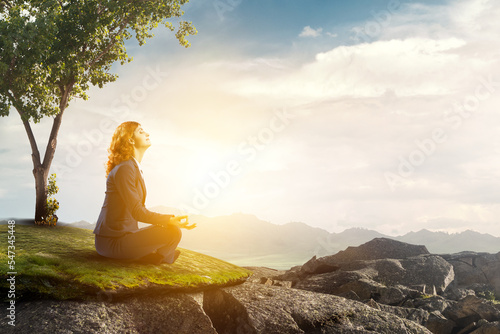 Beautiful businesswoman meditating . Mixed media