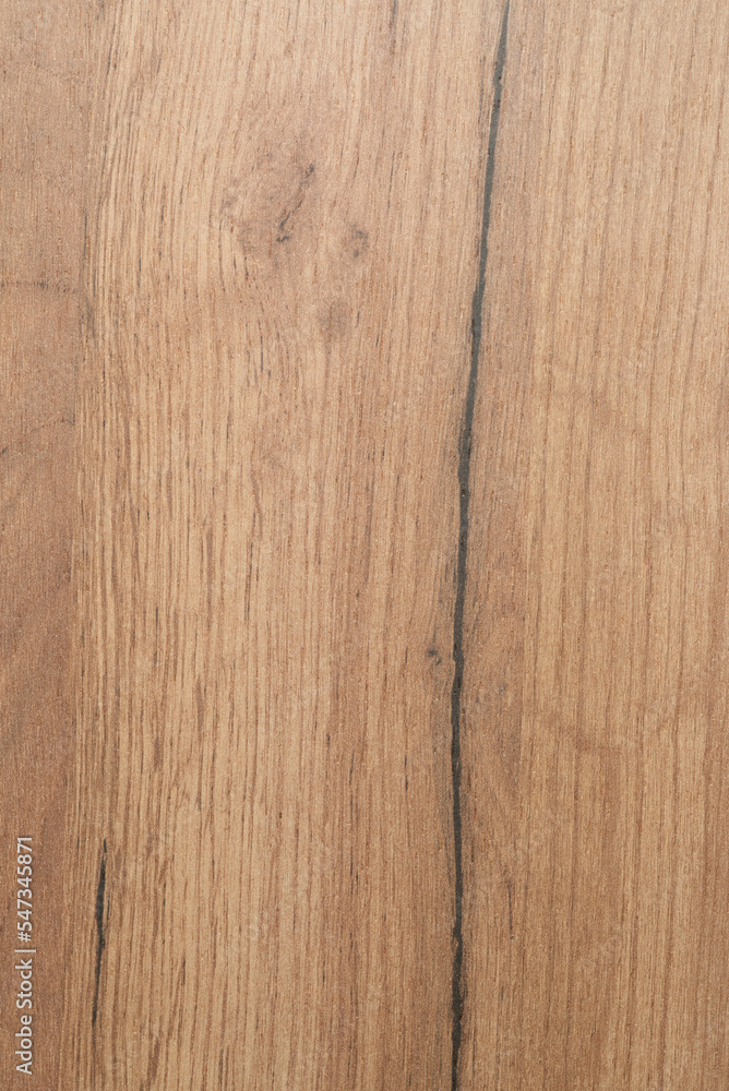 Fototapeta premium The wood texture of the cabinet lining is pale in color. With patterns. Vertical shot