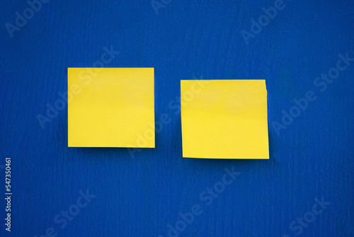 Selective focus. Yellow stickers on a blue board. Yellow and blue.