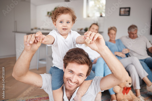 Happy, love and father with a baby on his shoulder while playing, bonding and relaxing in the living room. Happiness, fun and portrait of dad holding his boy toddler in the lounge of the family home.