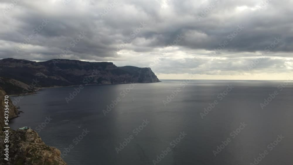 Calm cristal clear azure sea on background of rocky shores. Sunset over seascape and volcanic coastline. Perfect place for travel and rest. Never-ending beauty of nature. Calm cristal clear azure sea on background of rocky shores. Sunset over seascape and volcanic coastline. Perfect place for travel and rest. Never-ending beauty of nature.