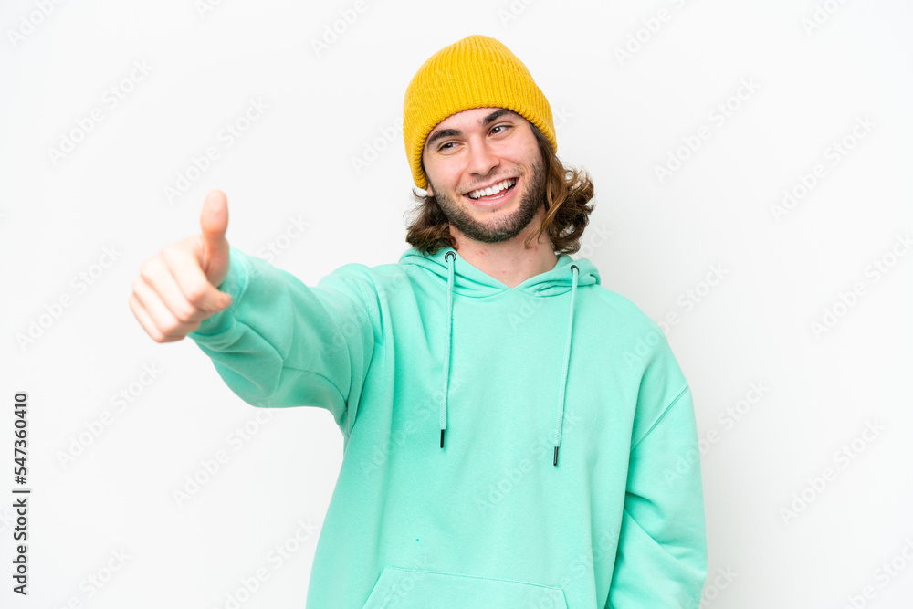 Young handsome man isolated on white chroma background giving a thumbs up gesture