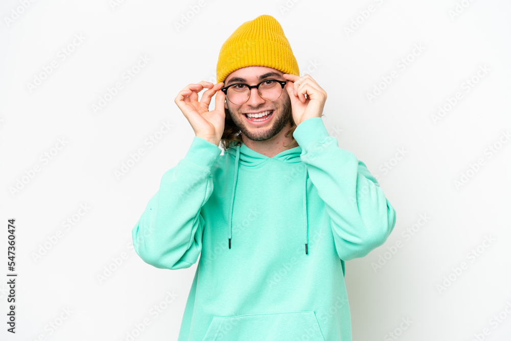 Young handsome man isolated on white chroma background with glasses and surprised Young handsome man isolated on white chroma background with glasses and surprised