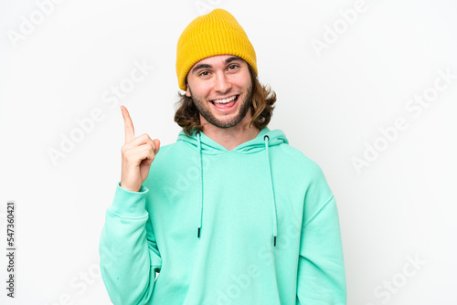 Young handsome man isolated on white chroma background showing and lifting a finger in sign of the best