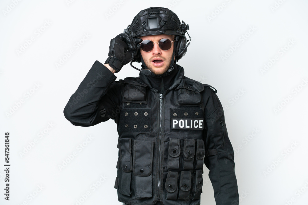 SWAT man over isolated white background with glasses and surprised SWAT man over isolated white background with glasses and surprised