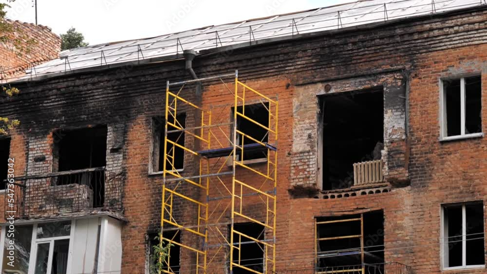 View from the street of a burned-out apartment in an apartment building after an explosion and fire. View from the street of a burned-out apartment in an apartment building after an explosion and fire.