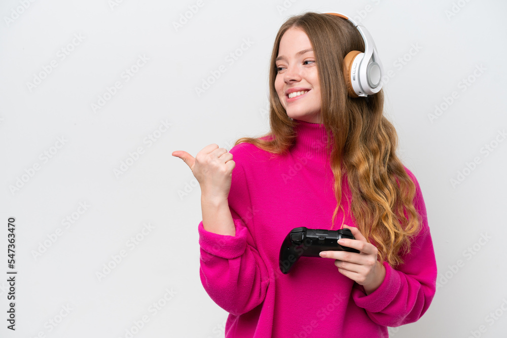 Naklejka premium Young pretty woman playing with a video game controller isolated on white background pointing to the side to present a product
