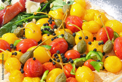 mediterranean products  yellow and red cherry tomatoes and capers