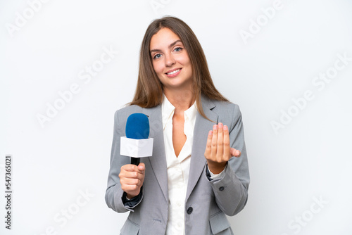 Young TV presenter caucasian woman isolated on white background inviting to come with hand. Happy that you came