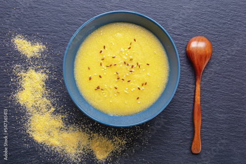 Healthy breakfast. Cornmeal porridge in  bowl on  table. Flat lay, copy space photo