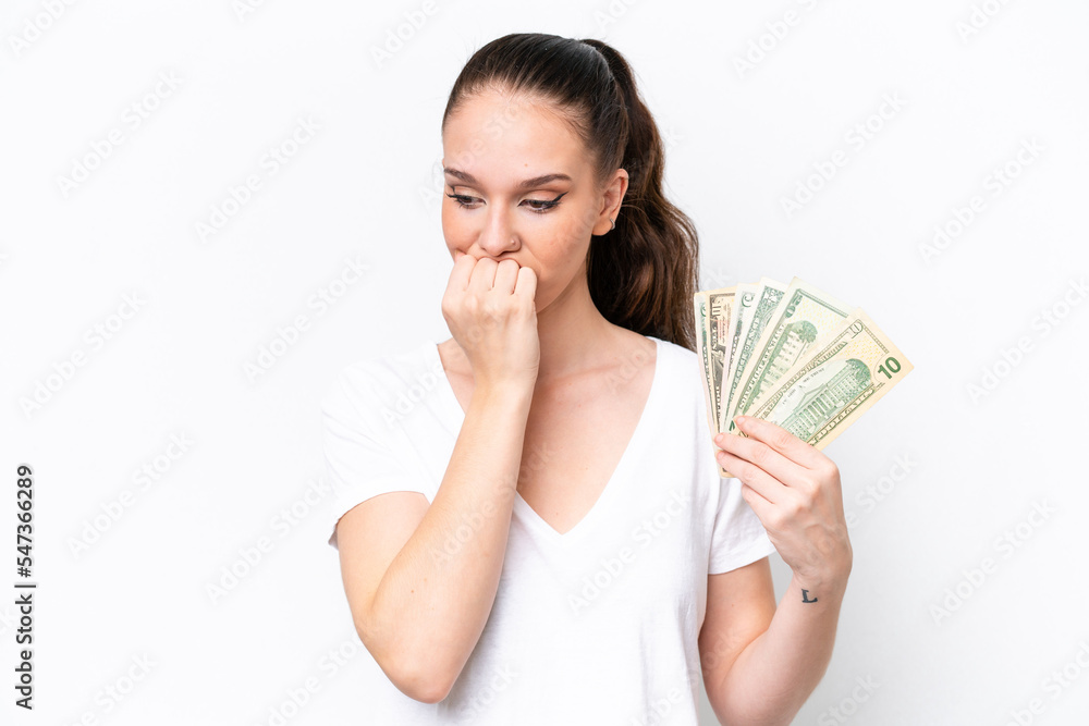 Young caucasian woman taking a lot of money isolated on white background having doubts Young caucasian woman taking a lot of money isolated on white background having doubts
