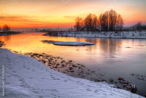 Winter landscape  amazing sundown in winter   Poland Europe  river valley Knyszyn Primeval Forest 