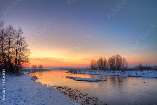 Winter landscape, amazing sundown in winter , Poland Europe, river valley Knyszyn Primeval Forest 