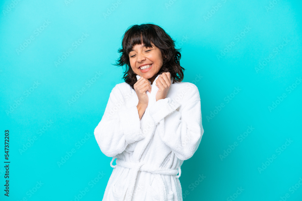 Young woman in a bathrobe with towel isolated on blue background Young woman in a bathrobe with towel isolated on blue background
