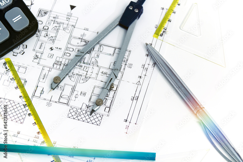 Designing a building or architecture with a ruler, pen, pencil, calculator and other equipment Designing a building or architecture with a ruler, pen, pencil, calculator and other equipment