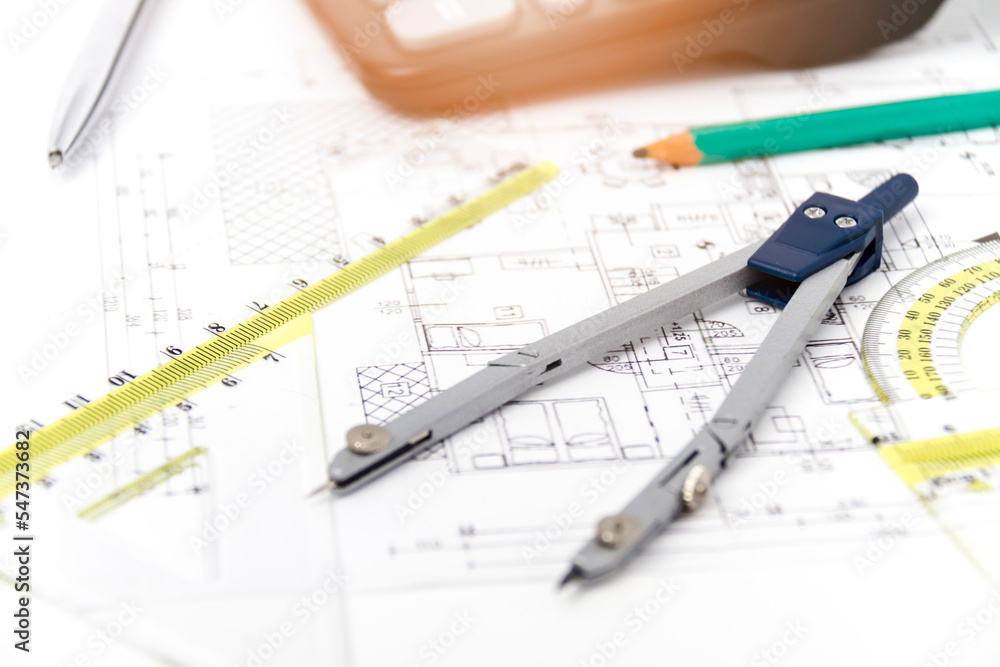 Designing a building or architecture with a ruler, pen, pencil, calculator and other equipment Designing a building or architecture with a ruler, pen, pencil, calculator and other equipment