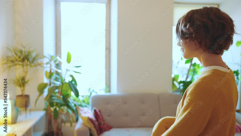 Pretty brunette woman wearing eyeglasses dancing at home Pretty brunette woman wearing eyeglasses dancing at home