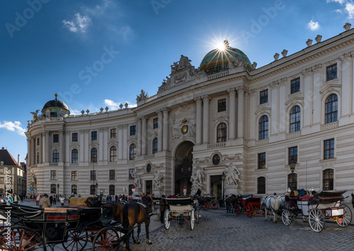 horse-drawn carriages outside of the historic Spanish Riding School building in Vienna