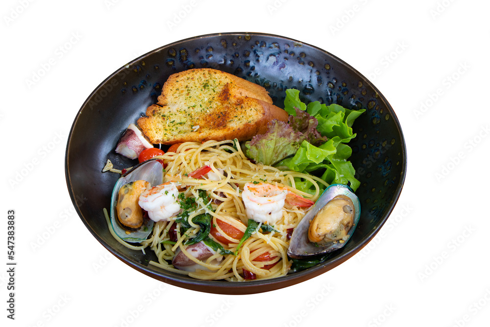 Stir-fried Spicy Spaghetti Seafood (Spaghetti Pad Kee Mao) Thai food style. Served in black tiled plate placed. Decorate with crispy bread vegetable Salad with mussels and shrimp Stir-fried Spicy Spaghetti Seafood (Spaghetti Pad Kee Mao) Thai food style. Served in black tiled plate placed. Decorate with crispy bread vegetable Salad with mussels and shrimp